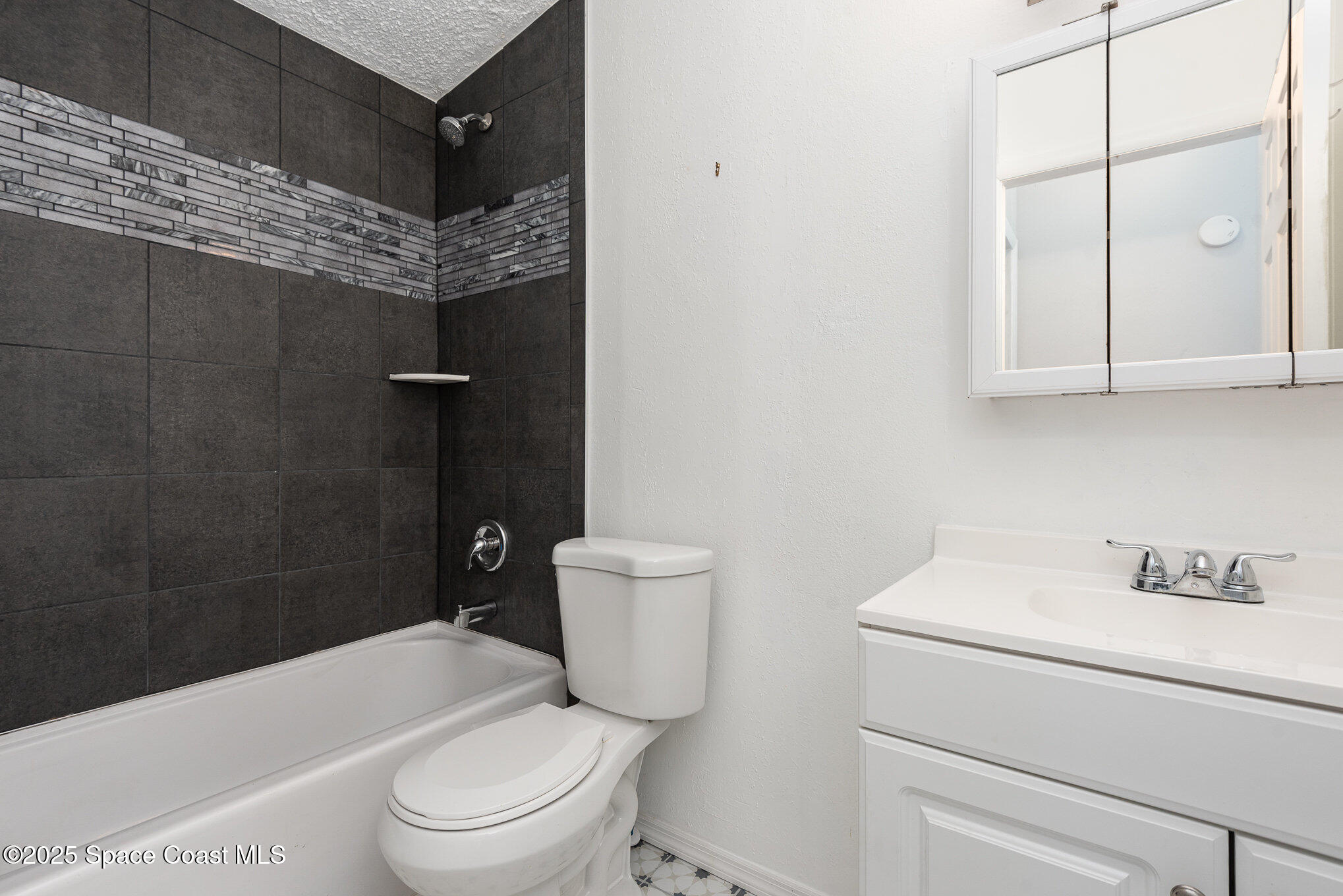 3115 Brockett Road Mims, FL 32754 - Photo 14 of 15 a white toilet sitting next to a bathroom sink and vanity