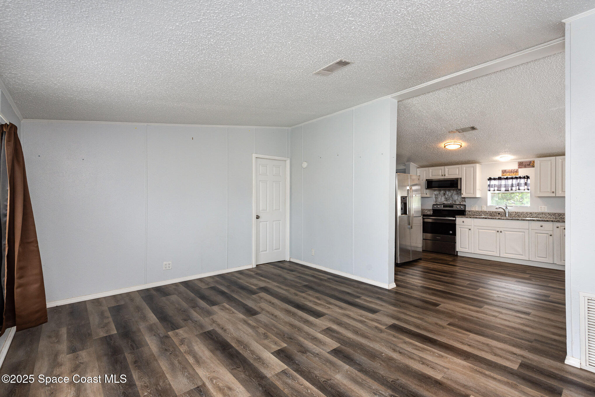 3115 Brockett Road Mims, FL 32754 - Photo 4 of 15 a view of kitchen view wooden floor and stainless steel appliances