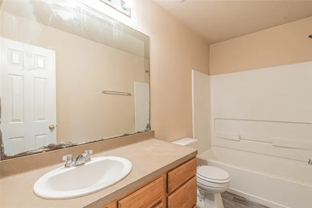 a bathroom with a sink a toilet and a mirror