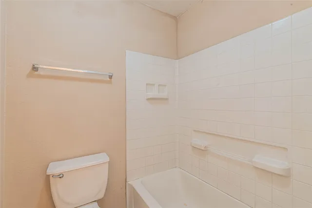 a bathroom with a toilet and bathtub