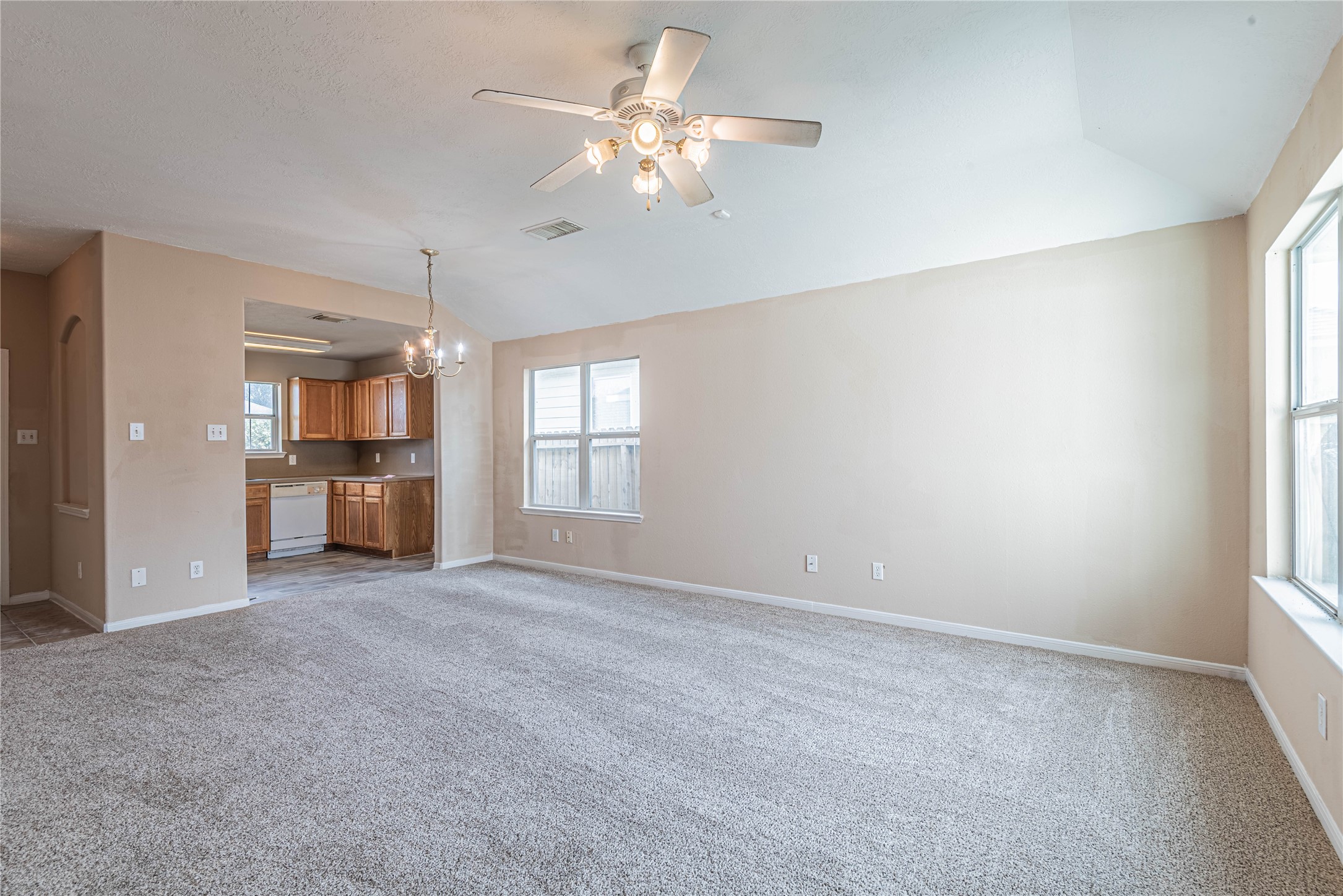 21135 Sprouse Circle Humble, TX 77338 - Photo 7 of 18 an empty room with chandelier fan and windows