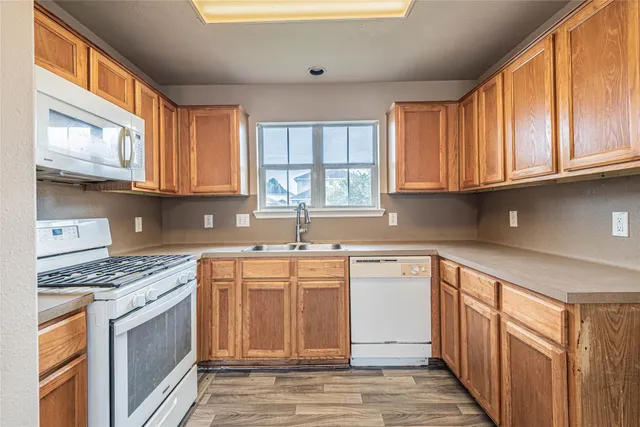 a kitchen with stainless steel appliances granite countertop a stove a sink and a granite counter tops