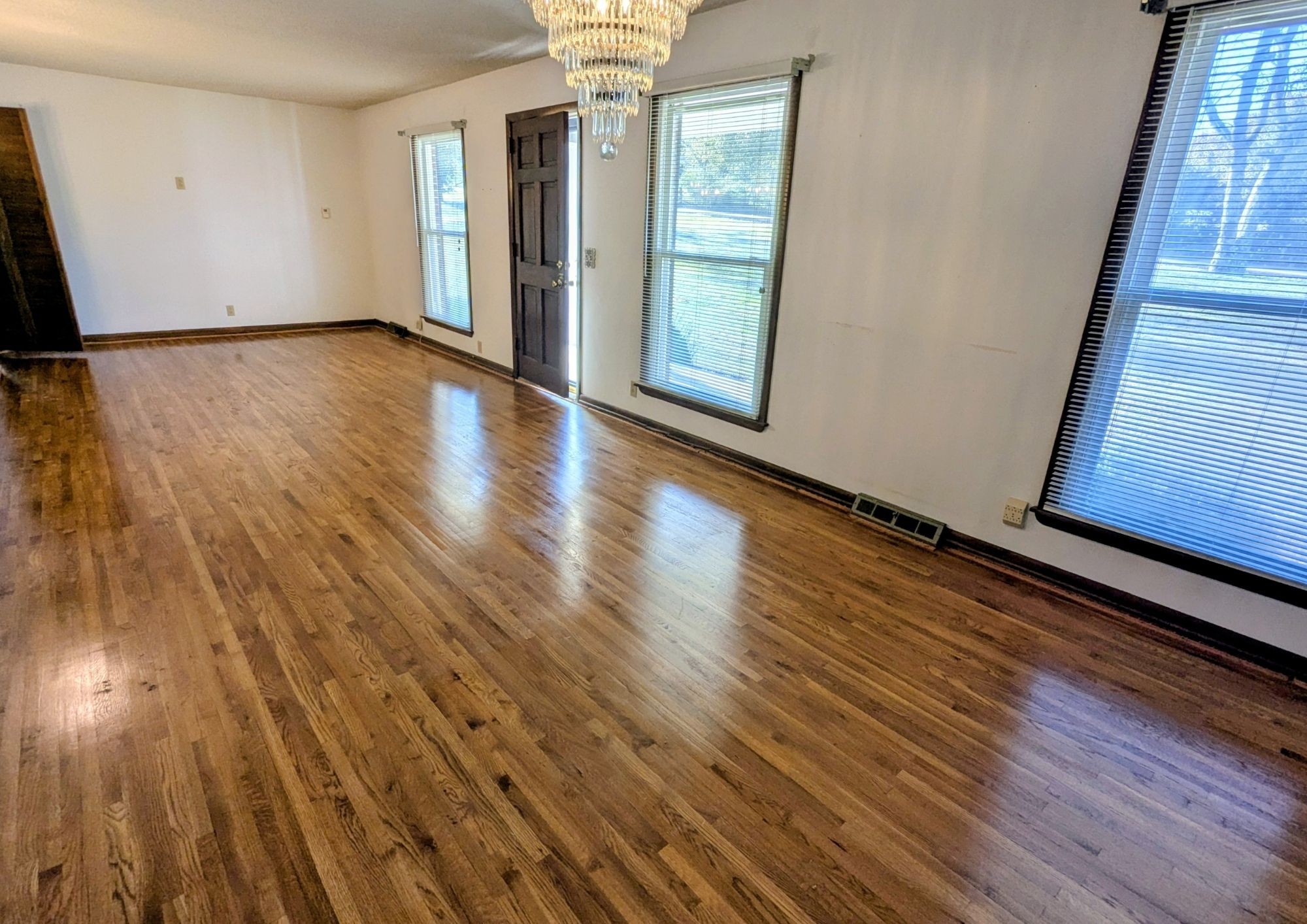 3042 Old Murfreesboro Road College Grove, TN 37046 - Photo 2 of 12 a view of an empty room with wooden floor and a window