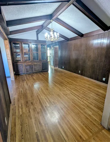 a view of an empty room with a fireplace and a window