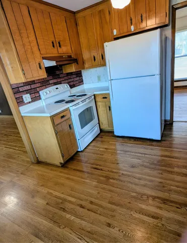 a view of a kitchen with wooden floor