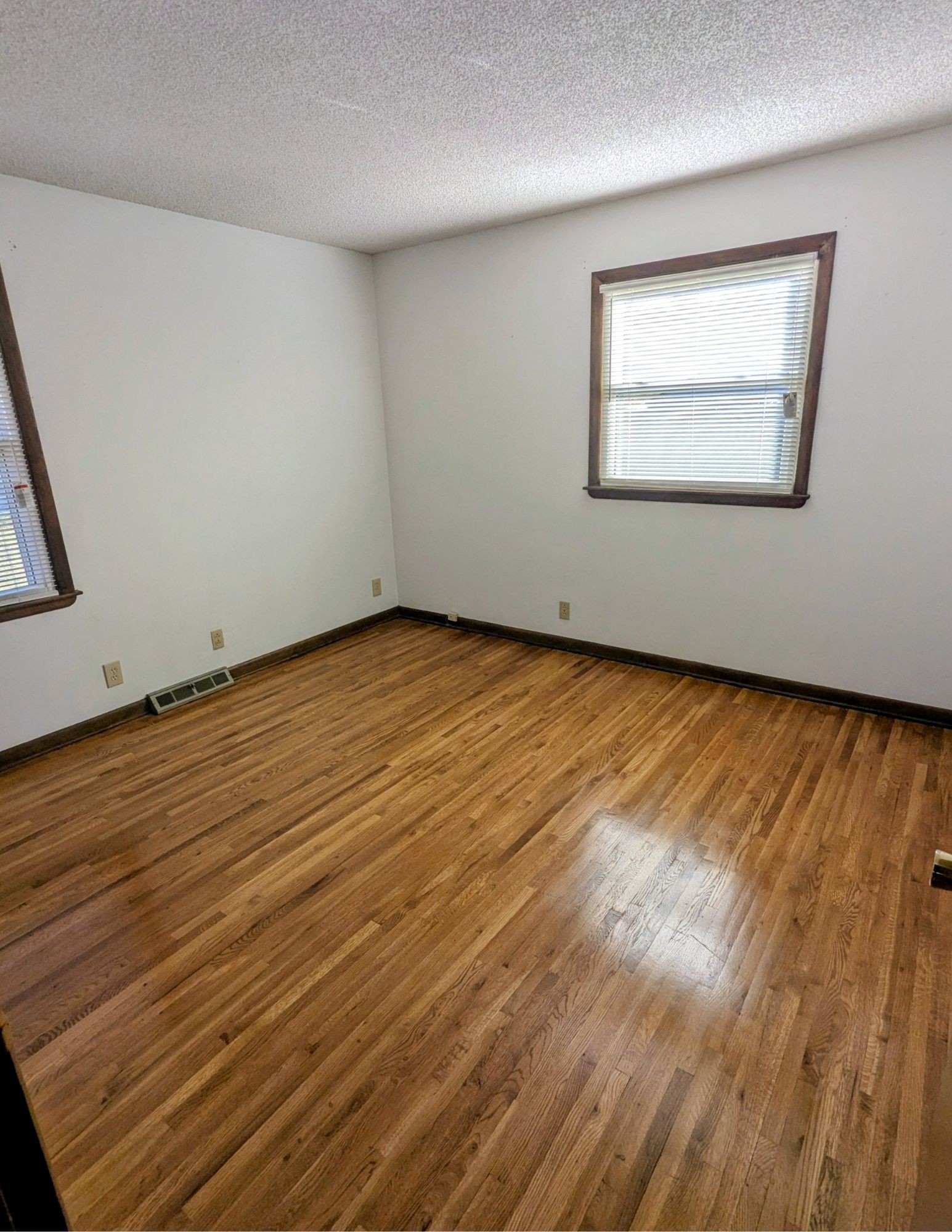 3042 Old Murfreesboro Road College Grove, TN 37046 - Photo 9 of 12 a view of an empty room with wooden floor and a window