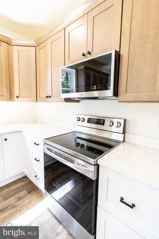 a view of a kitchen with wooden floor and window