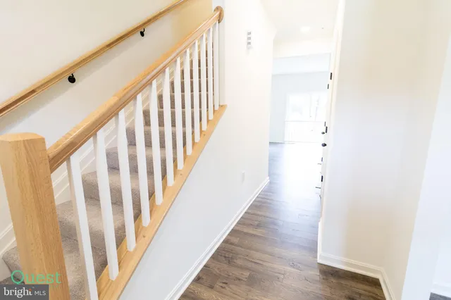 an empty room with wooden floor and a window