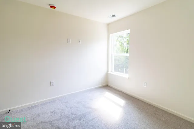 a view of a room with wooden floor and windows