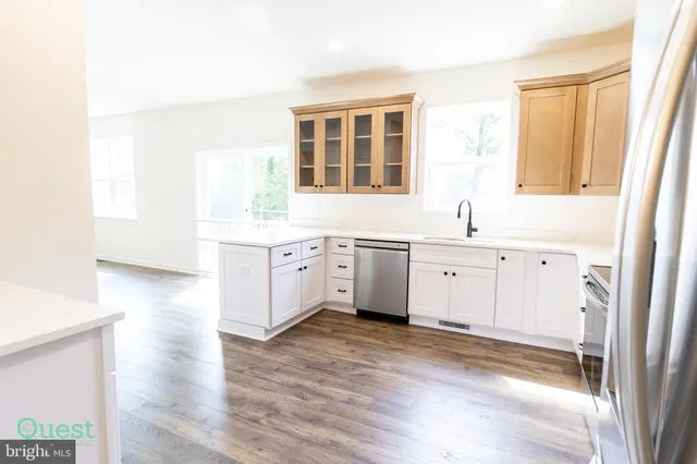 a kitchen with stainless steel appliances a stove sink and microwave