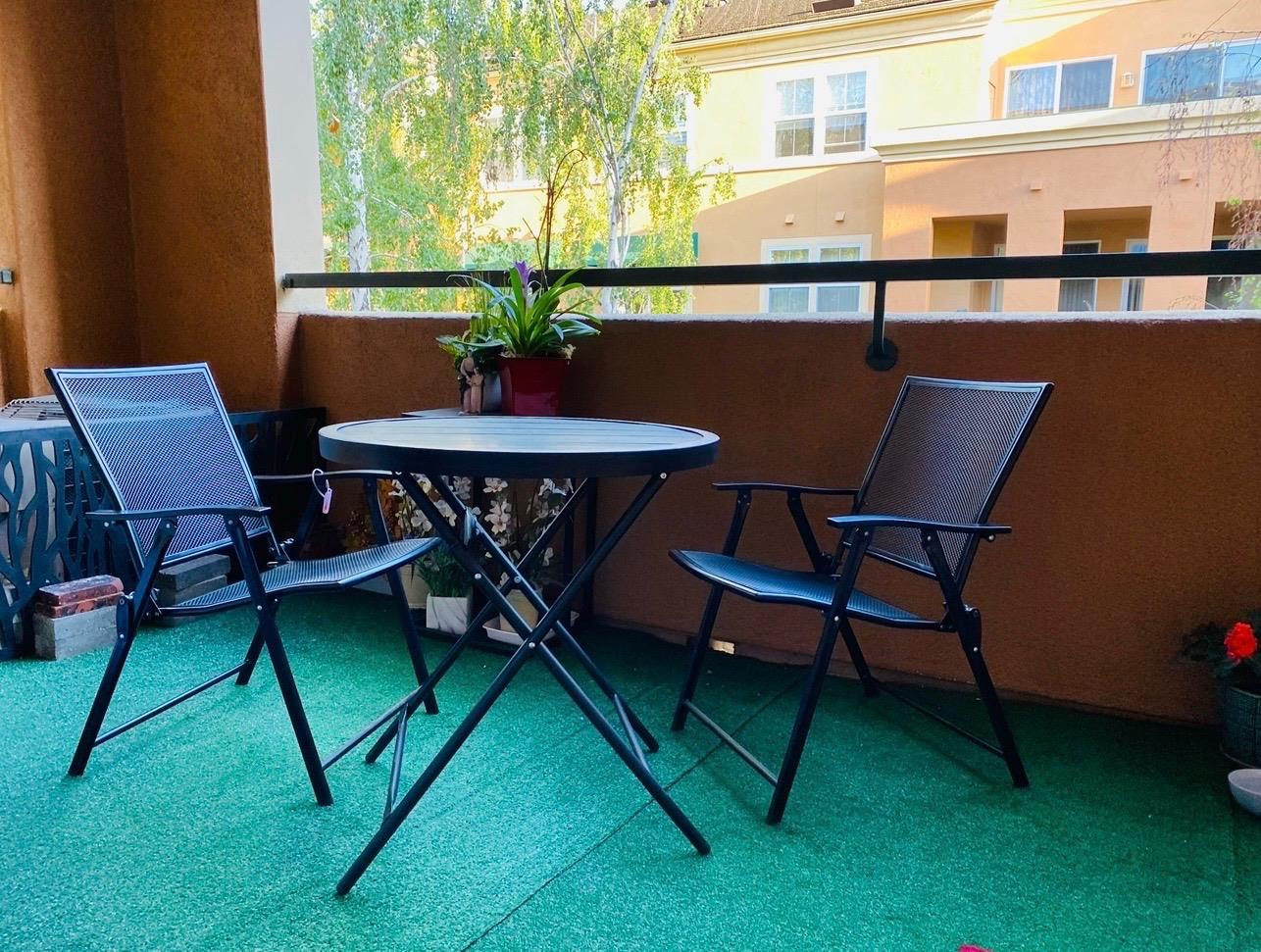 1310 Saddle Rack Street, Unit 347 San Jose, CA 95126 - Photo 27 of 42 a table and chairs in front of a building