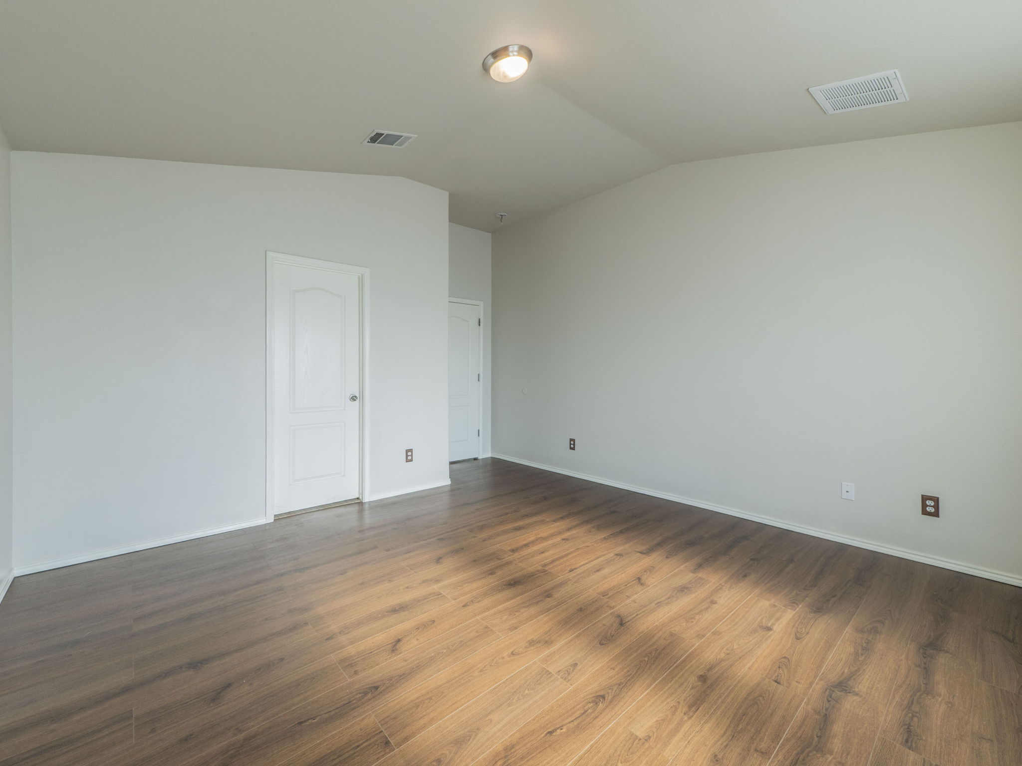 3209 Wickham Lane Austin, TX 78725 - Photo 11 of 26 Empty room featuring dark wood-style flooring and vaulted ceiling