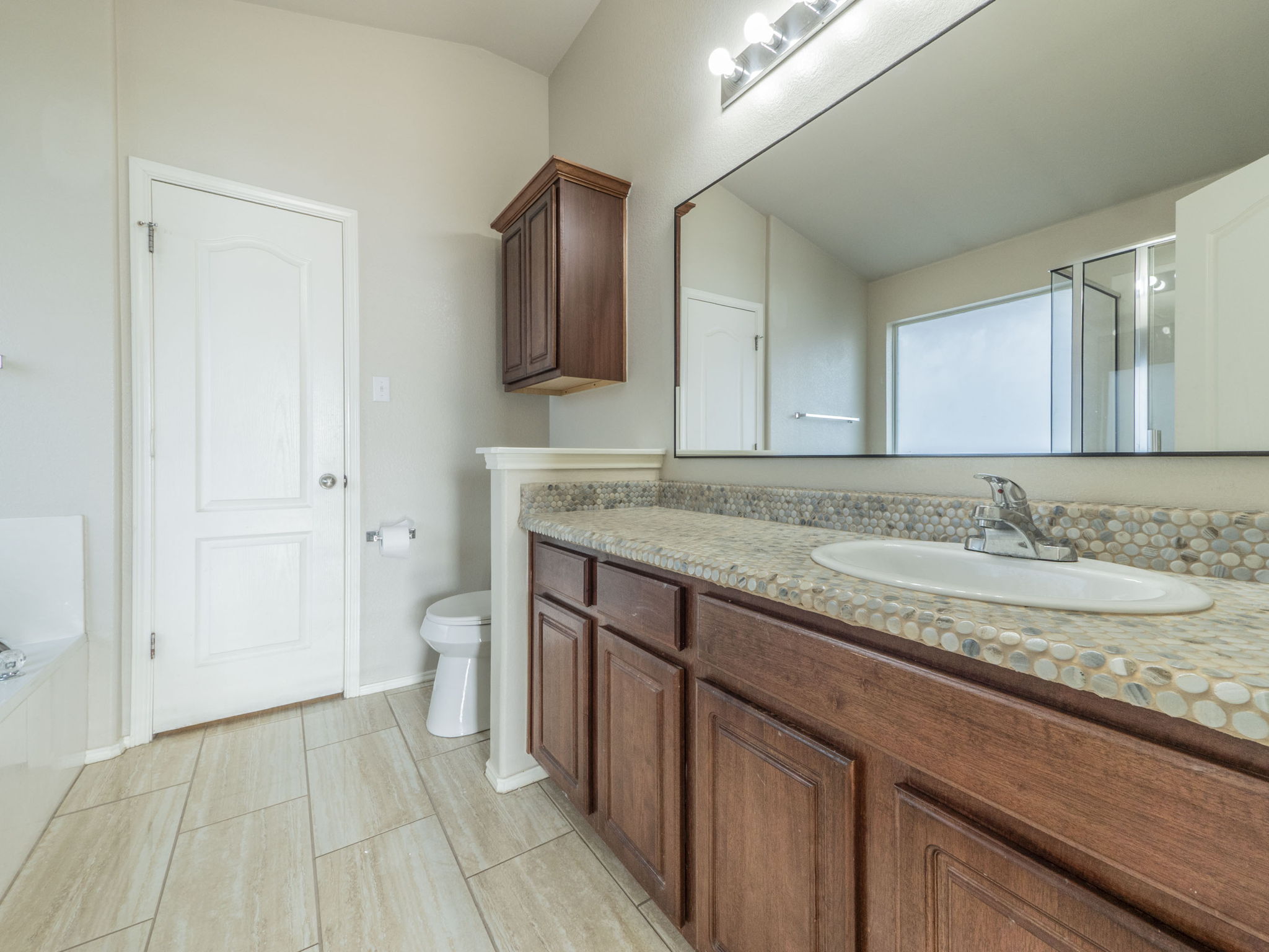 3209 Wickham Lane Austin, TX 78725 - Photo 12 of 26 Bathroom featuring vanity, a stall shower, a garden tub, and light tile patterned flooring