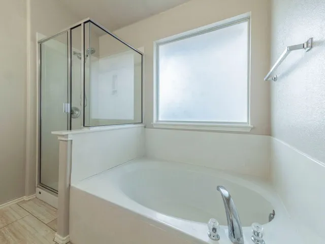 a bathroom with a tub and a shower
