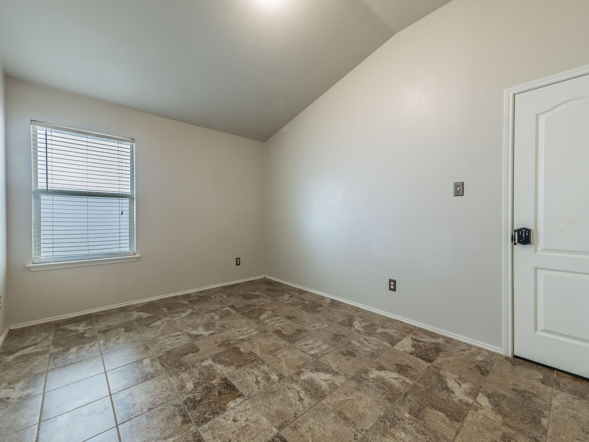 3209 Wickham Lane Austin, TX 78725 - Photo 14 of 26 Unfurnished room featuring vaulted ceiling and baseboards