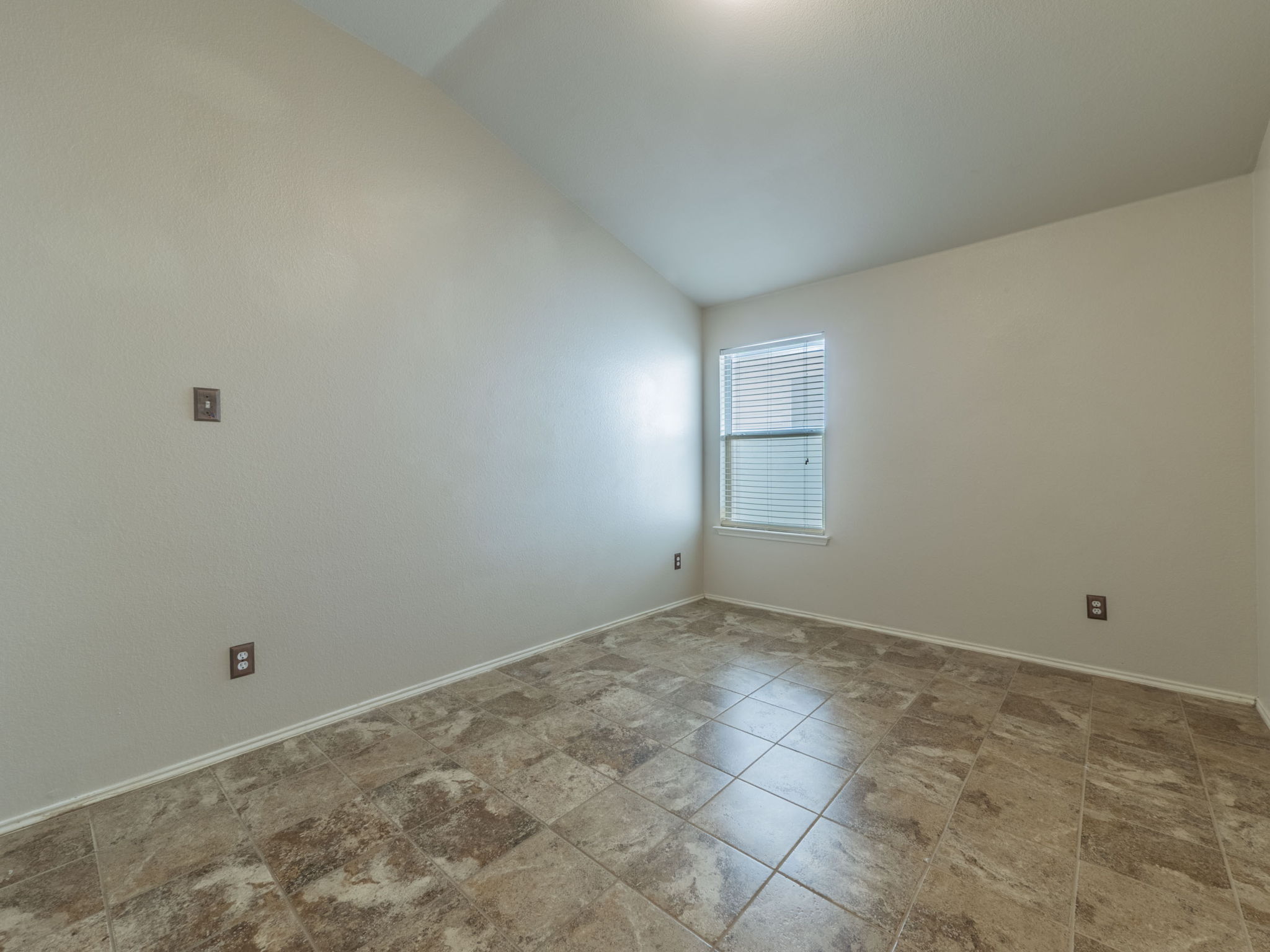 3209 Wickham Lane Austin, TX 78725 - Photo 15 of 26 Spare room with lofted ceiling and baseboards