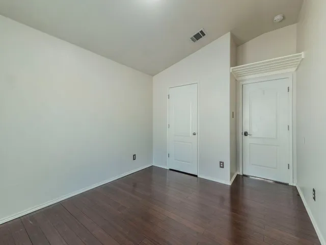 an empty room with wooden floor