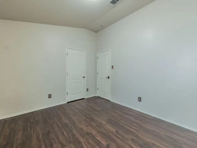 a view of room with wooden floor