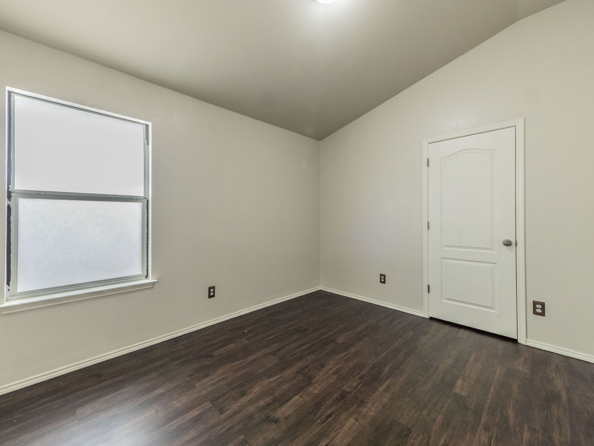 3209 Wickham Lane Austin, TX 78725 - Photo 21 of 26 Spare room with dark wood-style floors and lofted ceiling