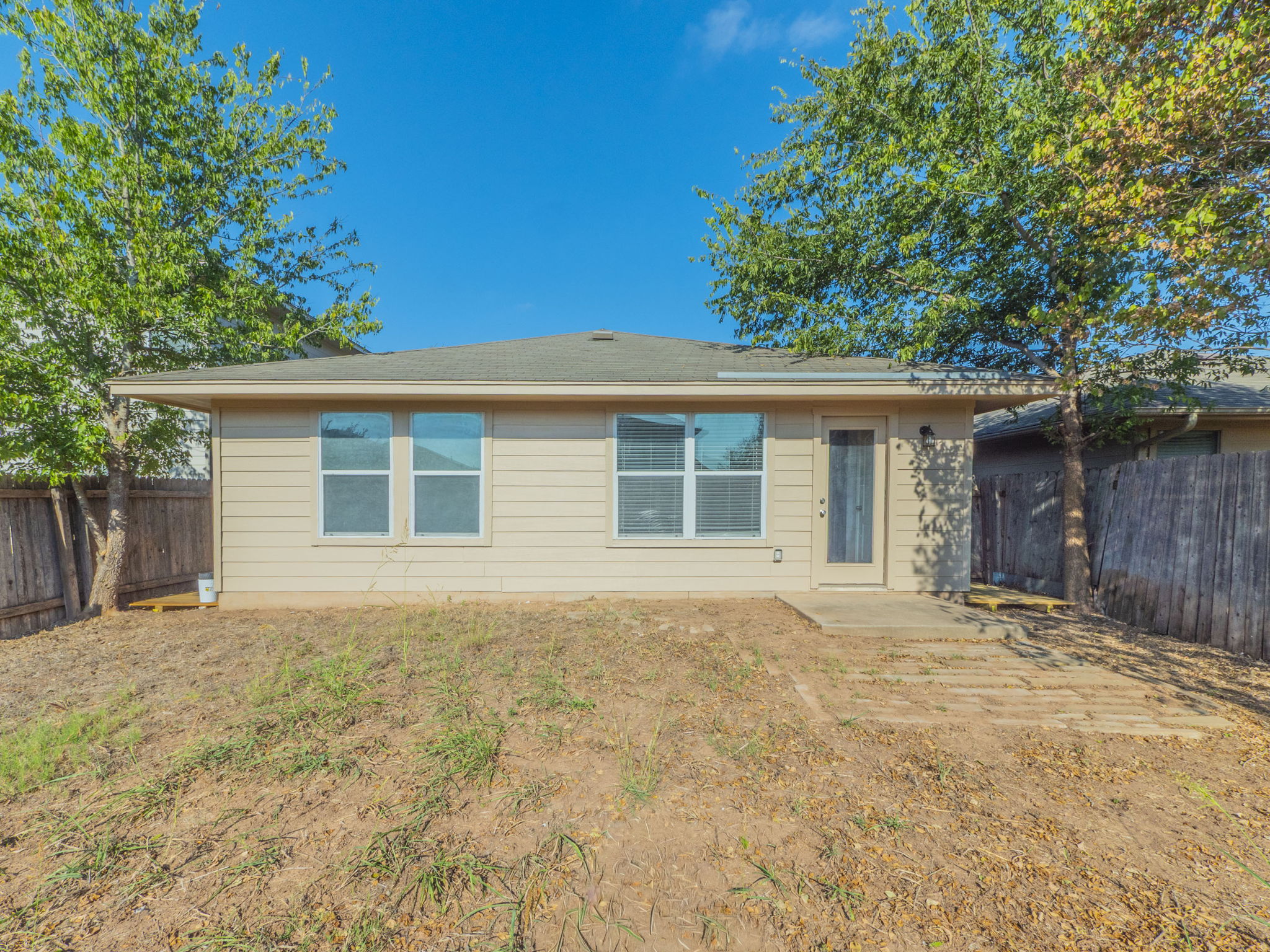 3209 Wickham Lane Austin, TX 78725 - Photo 23 of 26 Rear view of property with a patio area and a fenced backyard