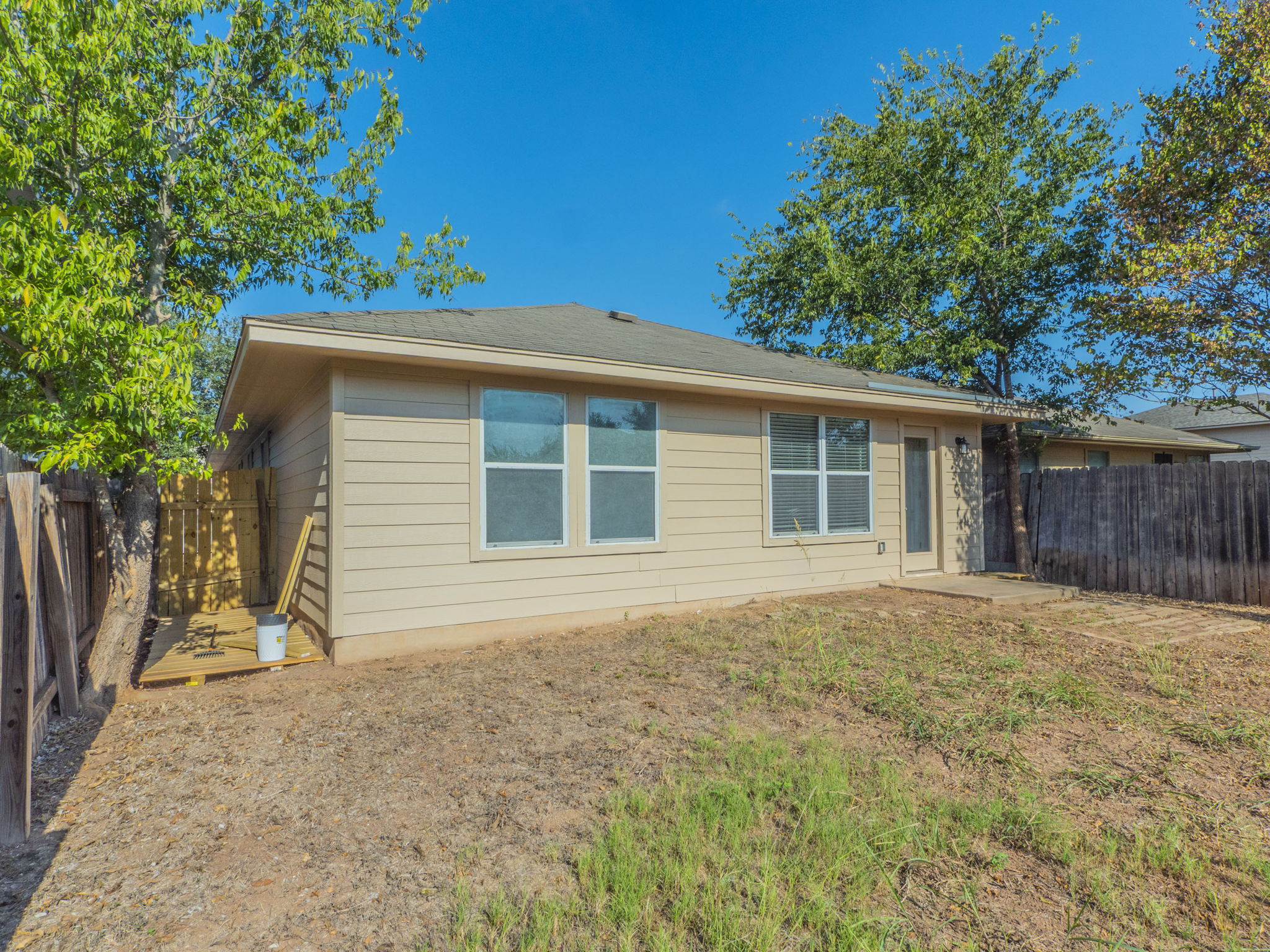 3209 Wickham Lane Austin, TX 78725 - Photo 25 of 26 Rear view of property with a fenced backyard