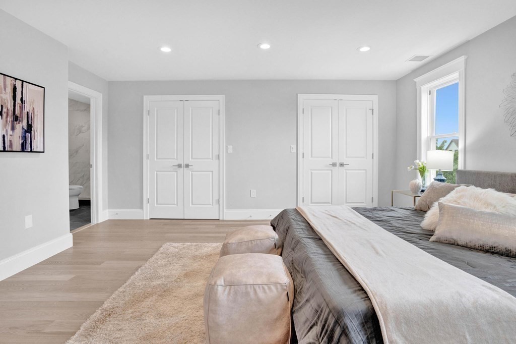 63 Kenmere Road, Unit 2 Medford, MA 02155 - Photo 20 of 42 a bedroom with a bed and a painting