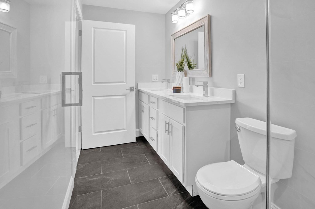 63 Kenmere Road, Unit 2 Medford, MA 02155 - Photo 23 of 42 a bathroom with a sink a toilet and mirror