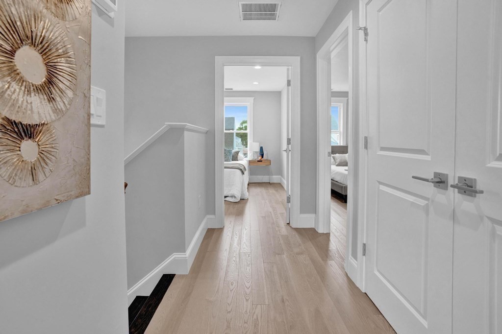 63 Kenmere Road, Unit 2 Medford, MA 02155 - Photo 24 of 42 a view of a hallway with wooden floor and staircase