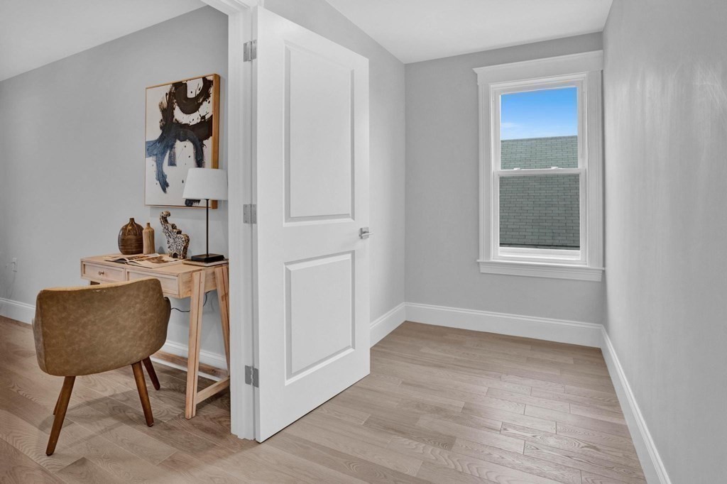 63 Kenmere Road, Unit 2 Medford, MA 02155 - Photo 29 of 42 a workspace room with a window and a chair