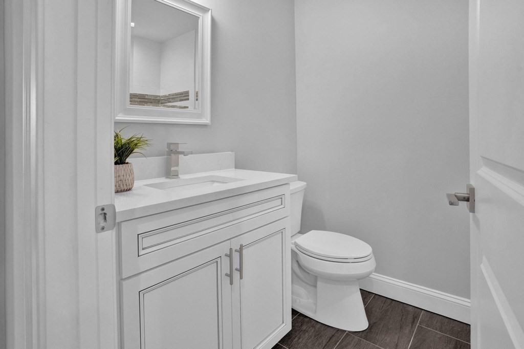 63 Kenmere Road, Unit 2 Medford, MA 02155 - Photo 30 of 42 a bathroom with a sink toilet and a mirror