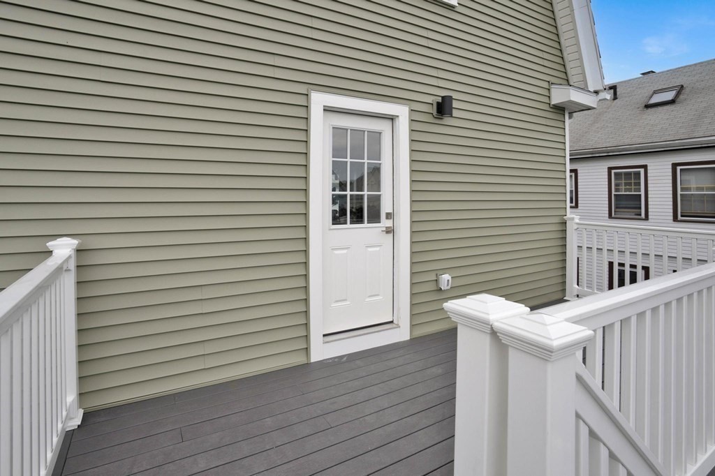 63 Kenmere Road, Unit 2 Medford, MA 02155 - Photo 35 of 42 a view of a house with a deck