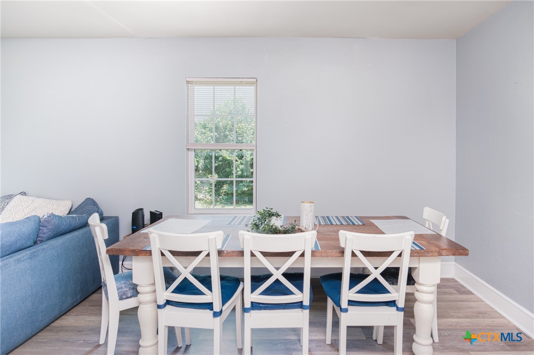 921 South 11th Street Temple, TX 76504 - Photo 11 of 23 a view of a dining room with furniture and wooden floor