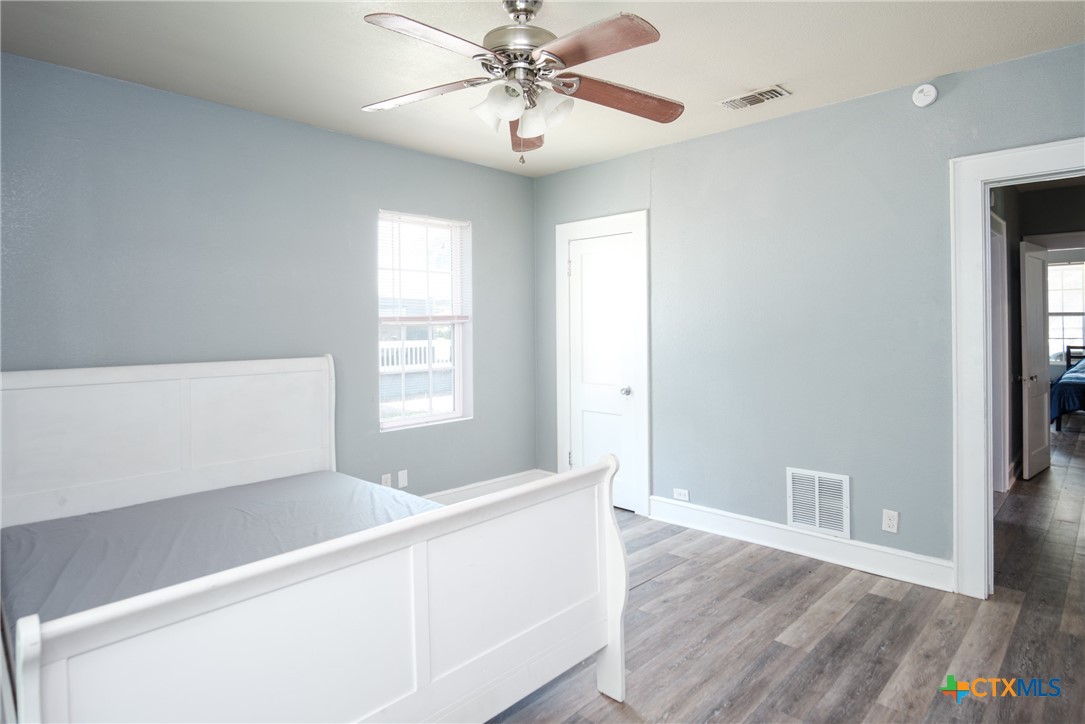 921 South 11th Street Temple, TX 76504 - Photo 13 of 23 a view of an empty room with window and wooden floor