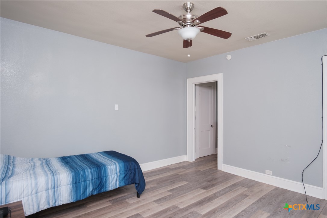 921 South 11th Street Temple, TX 76504 - Photo 19 of 23 a view of an empty room with wooden floor and a ceiling fan