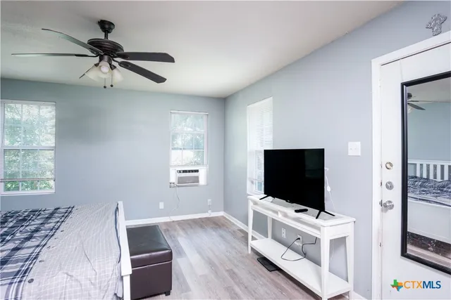 a living room with furniture and flat screen tv