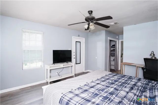 a bedroom with a bed and a flat screen tv