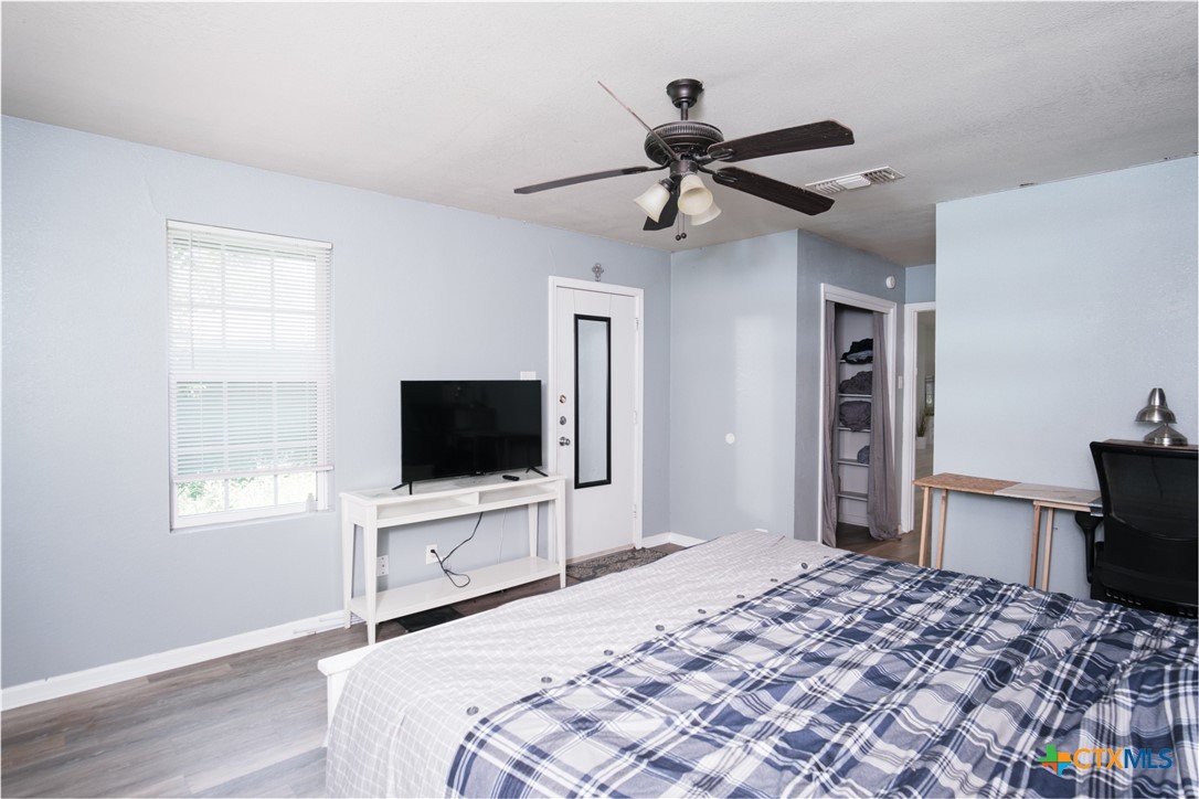 921 South 11th Street Temple, TX 76504 - Photo 22 of 23 a bedroom with a bed and a flat screen tv