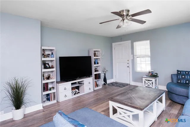 a living room with furniture and a flat screen tv