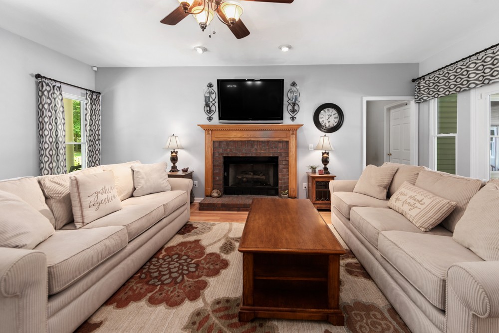 105 Spicer Road Burns, TN 37029 - Photo 11 of 44 a living room with furniture a flat screen tv and a fireplace