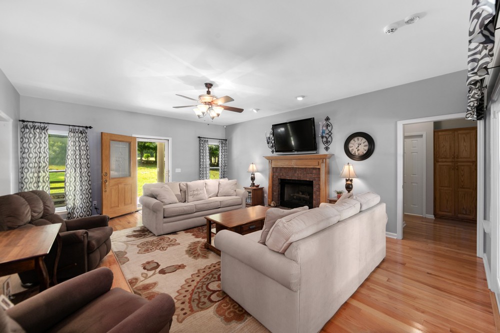 105 Spicer Road Burns, TN 37029 - Photo 12 of 44 a living room with furniture and a fireplace