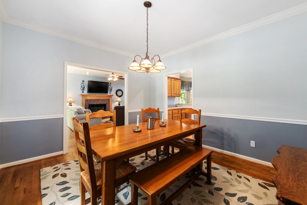105 Spicer Road Burns, TN 37029 - Photo 14 of 44 a view of a dining room with furniture and wooden floor