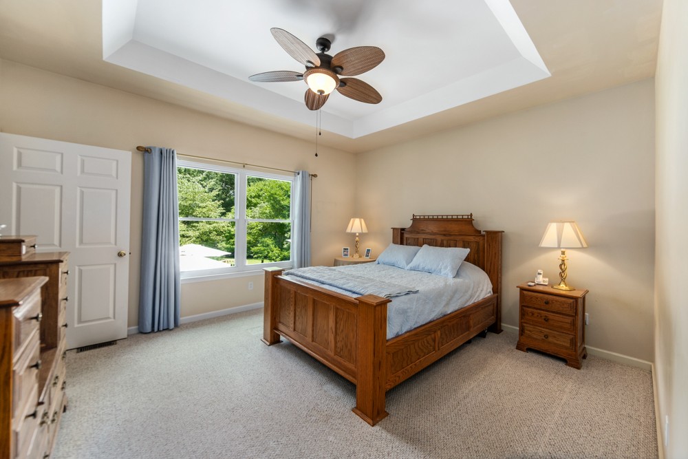 105 Spicer Road Burns, TN 37029 - Photo 20 of 44 a bedroom with a bed and a ceiling fan