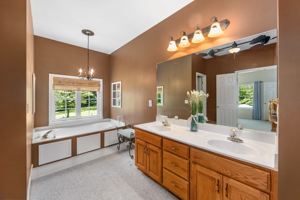 105 Spicer Road Burns, TN 37029 - Photo 21 of 44 a bathroom with a double vanity sink and a mirror