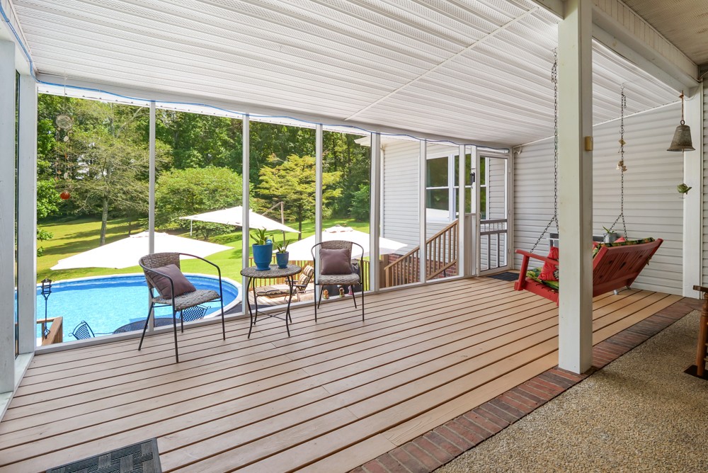 105 Spicer Road Burns, TN 37029 - Photo 29 of 44 a view of a patio with table and chairs and wooden floor