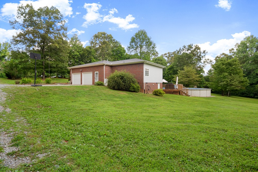 105 Spicer Road Burns, TN 37029 - Photo 36 of 44 a front view of a house with garden