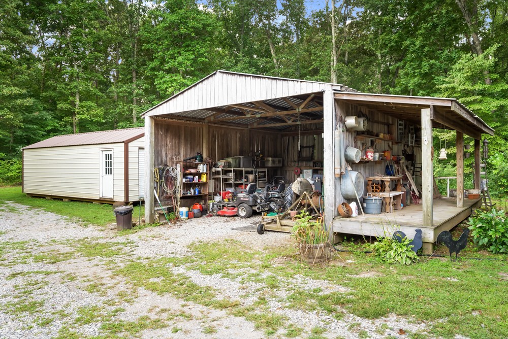 105 Spicer Road Burns, TN 37029 - Photo 37 of 44 a view of a patio with table and chairs under an umbrella