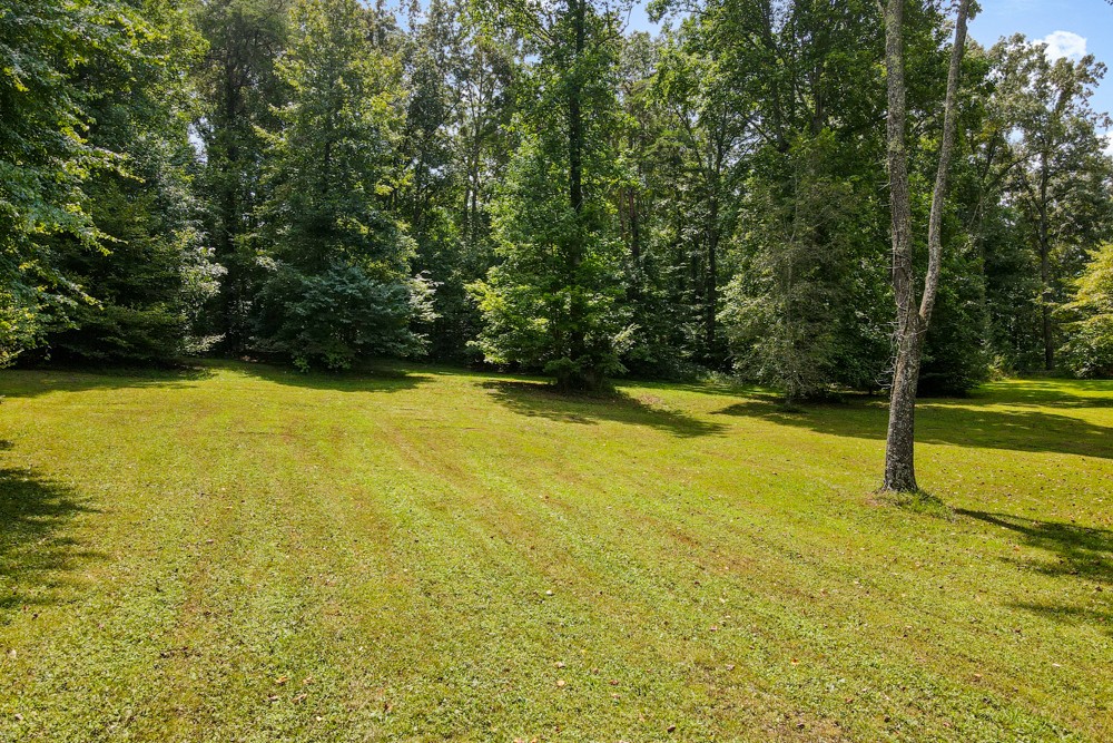 105 Spicer Road Burns, TN 37029 - Photo 40 of 44 a view of a swimming pool with an outdoor space and seating area