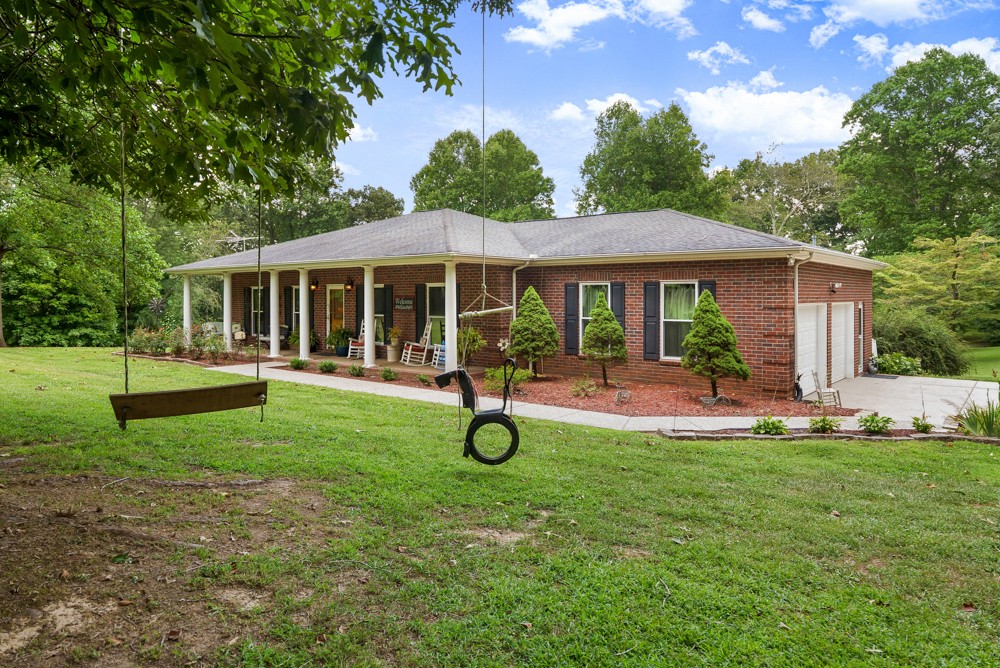 105 Spicer Road Burns, TN 37029 - Photo 6 of 44 a swimming pool with outdoor seating and yard