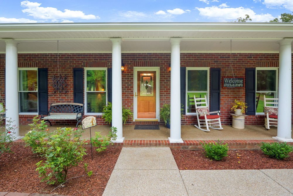 105 Spicer Road Burns, TN 37029 - Photo 7 of 44 a view of a brick house with outdoor seating