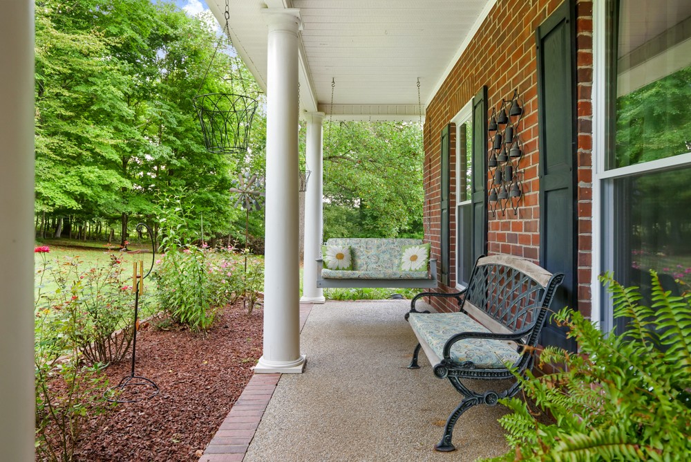 105 Spicer Road Burns, TN 37029 - Photo 9 of 44 a balcony view with outdoor seating and plants